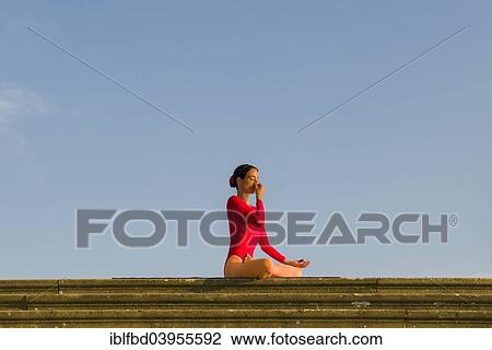"Young woman practising Hatha yoga, outdoors, showing the pose Anuloma Viloma, Nadi Shodhana Pranayama, alternate nostril breathing" View Large Photo Image Stock Image - "Young woman practising Hatha yoga, outdoors, showing the pose Anuloma Viloma, Nadi Shodhana Pranayama, alternate nostril breathing". Fotosearch