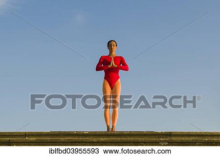 "Young woman practising Hatha yoga, outdoors, showing the pose Tadasana, Pranamasana, Prayer pose" View Large Photo Image Stock Image - "Young woman practising Hatha yoga, outdoors, showing the pose Tadasana, Pranamasana, Prayer pose". Fotosearch