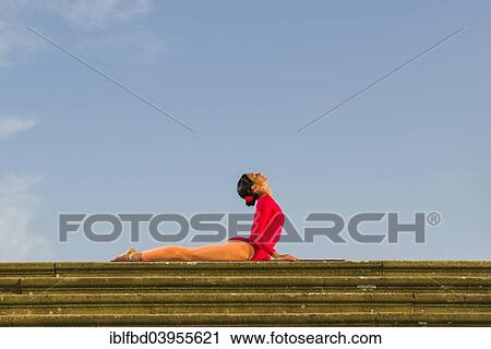 "Young woman practising Hatha yoga, outdoors, showing the pose Bhujangasana, Cobra pose" View Large Photo Image Stock Image - "Young woman practising Hatha yoga, outdoors, showing the pose Bhujangasana, Cobra pose". Fotosearch