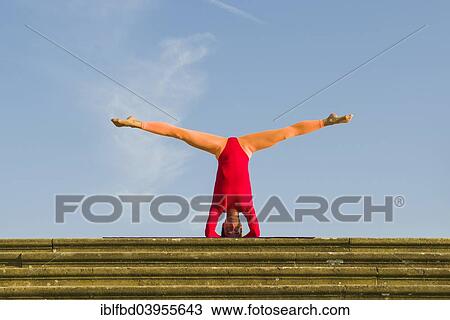 "Young woman practising Hatha yoga, outdoors, showing the pose Sirshasana, Head stand" View Large Photo Image Stock Image - "Young woman practising Hatha yoga, outdoors, showing the pose Sirshasana, Head stand". Fotosearch