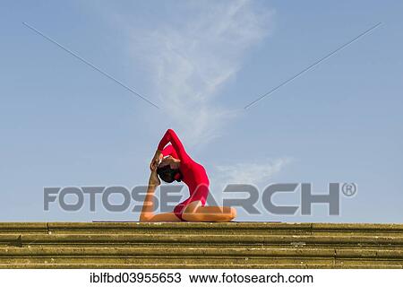"Young woman practising Hatha yoga, outdoors, showing the pose Kapotasana, Pigeon pose" View Large Photo Image Stock Image - "Young woman practising Hatha yoga, outdoors, showing the pose Kapotasana, Pigeon pose". Fotosearch