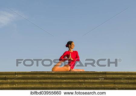"Young woman practising Hatha yoga, outdoors, showing the pose Kapotasana, Pigeon pose" View Large Photo Image Stock Image - "Young woman practising Hatha yoga, outdoors, showing the pose Kapotasana, Pigeon pose". Fotosearch