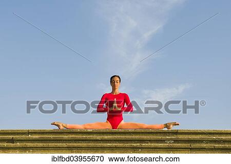 "Young woman practising Hatha yoga, outdoors, showing the pose Samakonasana, right angle pose, side split" View Large Photo Image Stock Image - "Young woman practising Hatha yoga, outdoors, showing the pose Samakonasana, right angle pose, side split". Fotosearch
