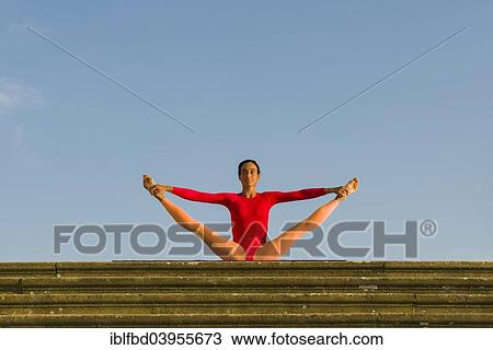 "Young woman practising Hatha yoga, outdoors, showing the pose Urdhva Mukha Pashchimottanasana, variation of unsupported back stretching pose" View Large Photo Image Stock Image - "Young woman practising Hatha yoga, outdoors, showing the pose Urdhva Mukha Pashchimottanasana, variation of unsupported back stretching pose". Fotosearch