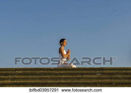 "Young woman practising Hatha yoga, outdoors, showing the pose Padmasana, Lotus pose" View Large Photo Image Stock Image - "Young woman practising Hatha yoga, outdoors, showing the pose Padmasana, Lotus pose". Fotosearch