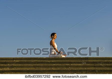 "Young woman practising Hatha yoga, outdoors, showing the pose Padmasana, Lotus pose" View Large Photo Image Stock Image - "Young woman practising Hatha yoga, outdoors, showing the pose Padmasana, Lotus pose". Fotosearch