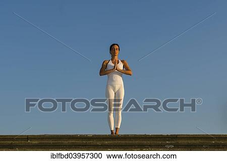 "Young woman practising Hatha yoga, outdoors, showing the pose Tadasana, Pranamasana, Prayer pose" View Large Photo Image Stock Image - "Young woman practising Hatha yoga, outdoors, showing the pose Tadasana, Pranamasana, Prayer pose". Fotosearch
