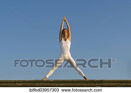 "Young woman practising Hatha yoga, outdoors, showing the pose Tadasana, Mountain pose, with legs apart" View Large Photo Image Stock Image - "Young woman practising Hatha yoga, outdoors, showing the pose Tadasana, Mountain pose, with legs apart". Fotosearch