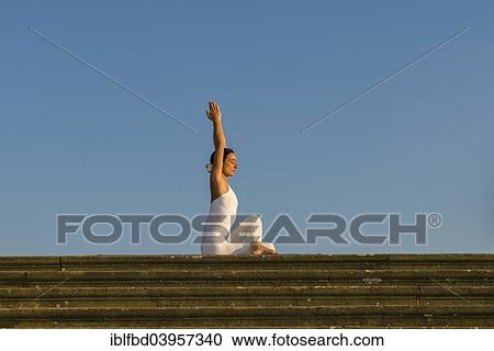 "Young woman practising Hatha yoga, outdoors, showing the pose Ardha matsyendrasana, Half spinal twist" View Large Photo Image Stock Image - "Young woman practising Hatha yoga, outdoors, showing the pose Ardha matsyendrasana, Half spinal twist". Fotosearch