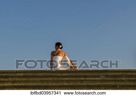 "Young woman practising Hatha yoga, outdoors, showing the pose Ardha matsyendrasana, Half spinal twist" View Large Photo Image Stock Image - "Young woman practising Hatha yoga, outdoors, showing the pose Ardha matsyendrasana, Half spinal twist". Fotosearch