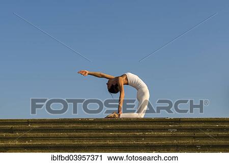 "Young woman practising Hatha yoga, outdoors, showing the pose Ushtrasana, Camel pose" View Large Photo Image Stock Image - "Young woman practising Hatha yoga, outdoors, showing the pose Ushtrasana, Camel pose". Fotosearch