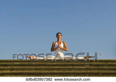 "Young woman practising Hatha yoga, outdoors, showing the pose Samakonasana, Right-angle pose, side split" View Large Photo Image Stock Image - "Young woman practising Hatha yoga, outdoors, showing the pose Samakonasana, Right-angle pose, side split". Fotosearch