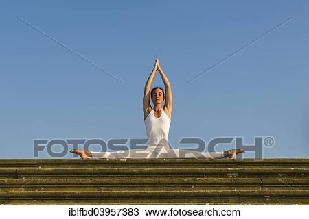 "Young woman practising Hatha yoga, outdoors, showing the pose Samakonasana, Right-angle pose, side split" View Large Photo Image Stock Image - "Young woman practising Hatha yoga, outdoors, showing the pose Samakonasana, Right-angle pose, side split". Fotosearch