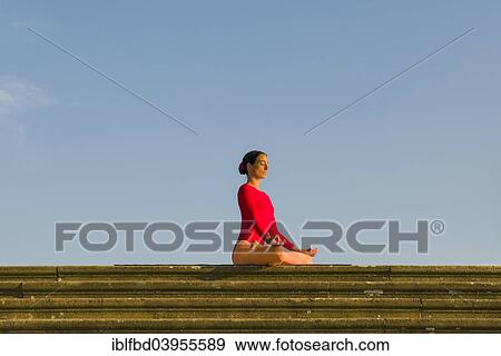 "Young woman practising Hatha yoga, outdoors, showing the pose Padmasana, Lotus pose" View Large Photo Image Stock Photo - "Young woman practising Hatha yoga, outdoors, showing the pose Padmasana, Lotus pose". Fotosearch