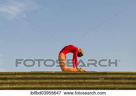 "Young woman practising Hatha yoga, outdoors, showing the pose Ushtrasana, Camel pose" View Large Photo Image Stock Photo - "Young woman practising Hatha yoga, outdoors, showing the pose Ushtrasana, Camel pose". Fotosearch