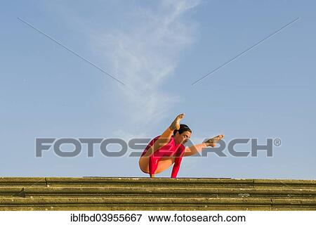 "Young woman practising Hatha yoga, outdoors, showing the pose Kakasana or Bakasana, Crow pose or Crane pose" View Large Photo Image Stock Photo - "Young woman practising Hatha yoga, outdoors, showing the pose Kakasana or Bakasana, Crow pose or Crane pose". Fotosearch