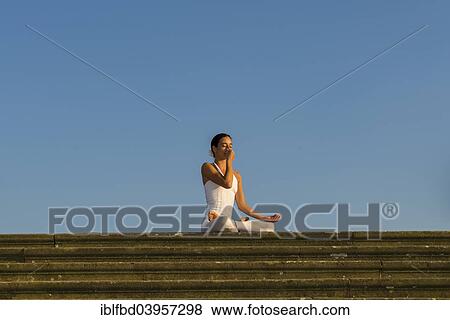 "Young woman practising Hatha yoga, outdoors, showing the pose Anuloma viloma, Nadi shodhana pranayama, Alternate nostril breathing" View Large Photo Image Stock Photo - "Young woman practising Hatha yoga, outdoors, showing the pose Anuloma viloma, Nadi shodhana pranayama, Alternate nostril breathing". Fotosearch