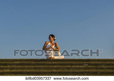 "Young woman practising Hatha yoga, outdoors, showing the pose Ardha matsyendrasana, Half spinal twist" View Large Photo Image Stock Photo - "Young woman practising Hatha yoga, outdoors, showing the pose Ardha matsyendrasana, Half spinal twist". Fotosearch