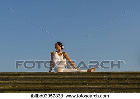 "Young woman practising Hatha yoga, outdoors, showing the pose Ardha matsyendrasana, Half spinal twist" View Large Photo Image Stock Photo - "Young woman practising Hatha yoga, outdoors, showing the pose Ardha matsyendrasana, Half spinal twist". Fotosearch