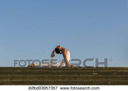 "Young woman practising Hatha yoga, outdoors, showing the pose Bhujangasana, Cobra pose" View Large Photo Image Stock Photo - "Young woman practising Hatha yoga, outdoors, showing the pose Bhujangasana, Cobra pose". Fotosearch