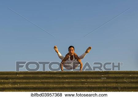 "Young woman practising Hatha yoga, outdoors, showing the pose Kakasana, Bakasana, variation of Crow pose, Crane pose" View Large Photo Image Stock Photo - "Young woman practising Hatha yoga, outdoors, showing the pose Kakasana, Bakasana, variation of Crow pose, Crane pose". Fotosearch