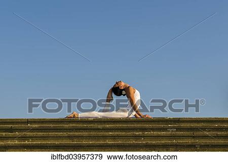 "Young woman practising Hatha yoga, outdoors, showing the pose Bhujangasana, Cobra pose" View Large Photo Image Stock Photo - "Young woman practising Hatha yoga, outdoors, showing the pose Bhujangasana, Cobra pose". Fotosearch