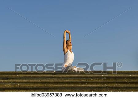 "Young woman practising Hatha yoga, outdoors, showing the pose Padmasana, variation of Lotus pose" View Large Photo Image Stock Photo - "Young woman practising Hatha yoga, outdoors, showing the pose Padmasana, variation of Lotus pose". Fotosearch