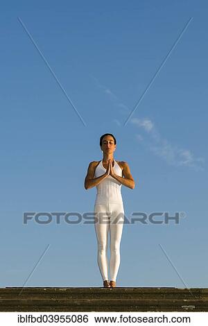 "Young woman practising Hatha yoga, outdoors, showing the pose Tadasana, Pranamasana, Prayer pose" View Large Photo Image Stock Photograph - "Young woman practising Hatha yoga, outdoors, showing the pose Tadasana, Pranamasana, Prayer pose". Fotosearch