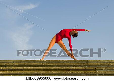 "Young woman practising Hatha yoga, outdoors, showing the pose Trikonasana, Triangle" View Large Photo Image Stock Photograph - "Young woman practising Hatha yoga, outdoors, showing the pose Trikonasana, Triangle". Fotosearch