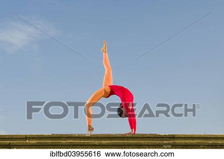 "Young woman practising Hatha yoga, outdoors, showing the pose Chakrasana, Urdhva Dhanurasana, Wheel pose" View Large Photo Image Stock Photograph - "Young woman practising Hatha yoga, outdoors, showing the pose Chakrasana, Urdhva Dhanurasana, Wheel pose". Fotosearch