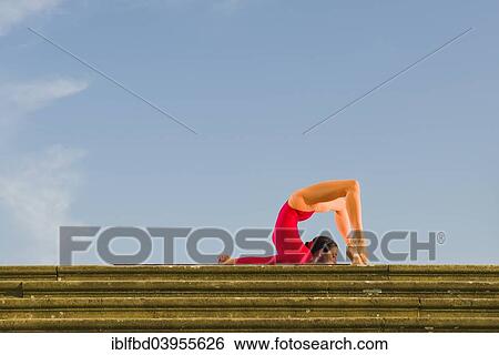 "Young woman practising Hatha yoga, outdoors, showing the pose poorna Shalabhasana, full Locust" View Large Photo Image Stock Photograph - "Young woman practising Hatha yoga, outdoors, showing the pose poorna Shalabhasana, full Locust". Fotosearch