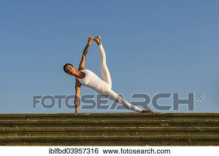 "Young woman practising Hatha yoga, outdoors, showing the pose Vasisthasana, Sage Vashishta's pose" View Large Photo Image Stock Photograph - "Young woman practising Hatha yoga, outdoors, showing the pose Vasisthasana, Sage Vashishta's pose". Fotosearch