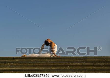 "Young woman practising Hatha yoga, outdoors, showing the pose Bhujangasana, Cobra pose" View Large Photo Image Stock Photograph - "Young woman practising Hatha yoga, outdoors, showing the pose Bhujangasana, Cobra pose". Fotosearch