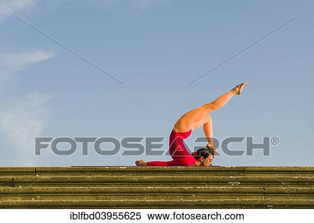 "Young woman practising Hatha yoga, outdoors, showing the pose Shalabhasana, Locust" View Large Photo Image Stock Photography - "Young woman practising Hatha yoga, outdoors, showing the pose Shalabhasana, Locust". Fotosearch