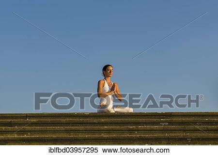 "Young woman practising Hatha yoga, outdoors, showing the pose Padmasana, Lotus pose" View Large Photo Image Stock Photography - "Young woman practising Hatha yoga, outdoors, showing the pose Padmasana, Lotus pose". Fotosearch