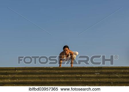 "Young woman practising Hatha yoga, outdoors, showing the pose Parshva kakasana, Parshva bakasana, Sideward crow pose, Sideward crane pose" View Large Photo Image Stock Photography - "Young woman practising Hatha yoga, outdoors, showing the pose Parshva kakasana, Parshva bakasana, Sideward crow pose, Sideward crane pose". Fotosearch