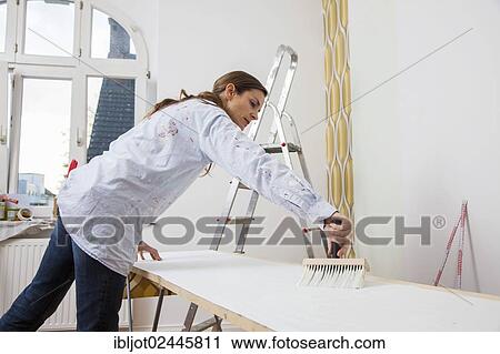 Young woman preparing wallpaper for wallpapering the walls View Large Photo Image Stock Image - Young woman preparing wallpaper for wallpapering the walls. Fotosearch