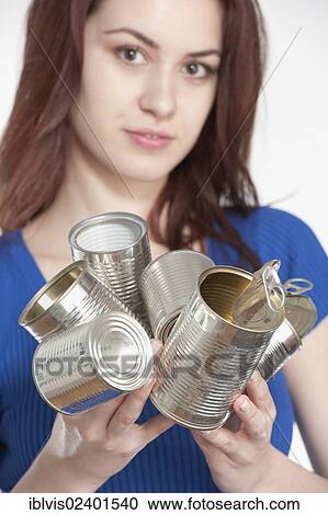 Young woman recycling tin cans View Large Photo Image Stock Image - Young woman recycling tin cans. Fotosearch