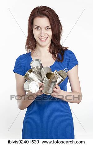 Young woman recycling tin cans View Large Photo Image Stock Photo - Young woman recycling tin cans. Fotosearch