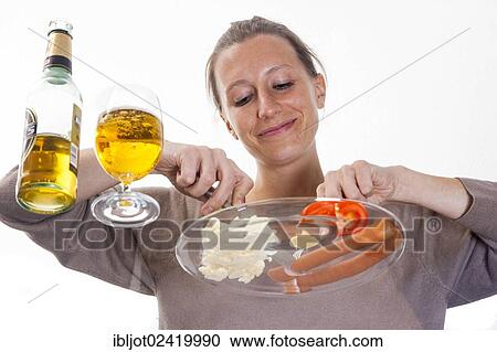 Young woman sitting at a glass table eating Frankfurter sausages with potato salad, mustard and a pilsner beer View Large Photo Image Stock Image - Young woman sitting at a glass table eating Frankfurter sausages with potato salad, mustard and a pilsner beer. Fotosearch