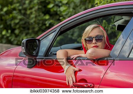 "Young woman sitting in a car, Germany, Europe" View Large Photo Image Stock Photo - "Young woman sitting in a car, Germany, Europe". Fotosearch