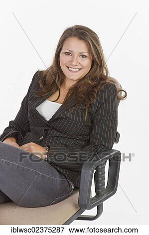 Stock Photo - Young woman sitting on an office chair. Fotosearch