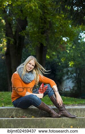 Young woman sitting on stone steps View Large Photo Image Stock Photo - Young woman sitting on stone steps. Fotosearch