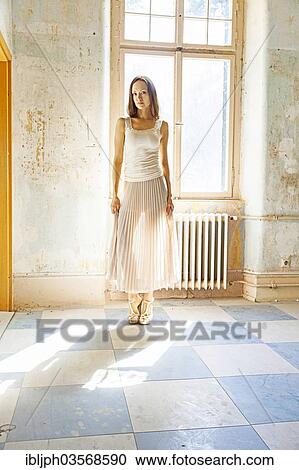 "Young woman standing at a wall with peeling paint, Germany, Europe" View Large Photo Image Stock Image - "Young woman standing at a wall with peeling paint, Germany, Europe". Fotosearch