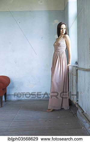 "Young woman standing in a room in need of redecoration, Germany, Europe" View Large Photo Image Stock Photo - "Young woman standing in a room in need of redecoration, Germany, Europe". Fotosearch