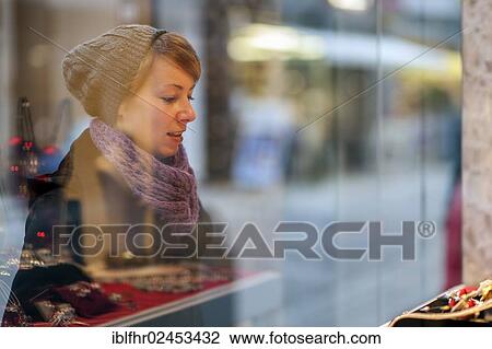 "Young woman standing in front of the window of a jewellery store, Grevenbroich, North Rhine-Westphalia, Germany, Europe" View Large Photo Image Stock Image - "Young woman standing in front of the window of a jewellery store, Grevenbroich, North Rhine-Westphalia, Germany, Europe". Fotosearch