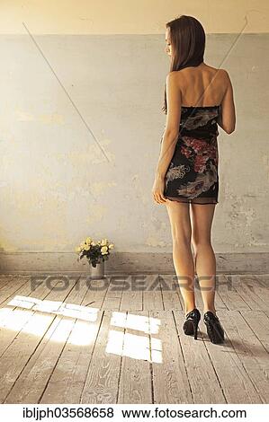 "Young woman standing next to a bunch of roses, Germany, Europe" View Large Photo Image Stock Photo - "Young woman standing next to a bunch of roses, Germany, Europe". Fotosearch
