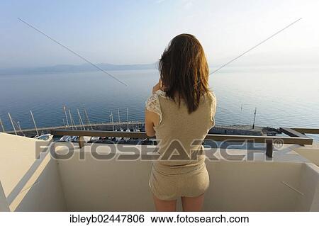 "Young woman standing on a balcony, overlooking Lake Geneva, Meillerie, Evian-les-Bains, France, Europe" View Large Photo Image Stock Photograph - "Young woman standing on a balcony, overlooking Lake Geneva, Meillerie, Evian-les-Bains, France, Europe". Fotosearch