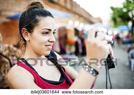 "Young woman taking pictures at a street market, Chiang Mai, Chiang Mai Province, Thailand, Asia" View Large Photo Image Picture - "Young woman taking pictures at a street market, Chiang Mai, Chiang Mai Province, Thailand, Asia". Fotosearch