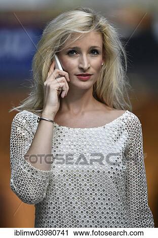 Stock Image - "Young woman using a mobile phone, Stuttgart, Baden-Wurttemberg, Germany, Europe". Fotosearch
